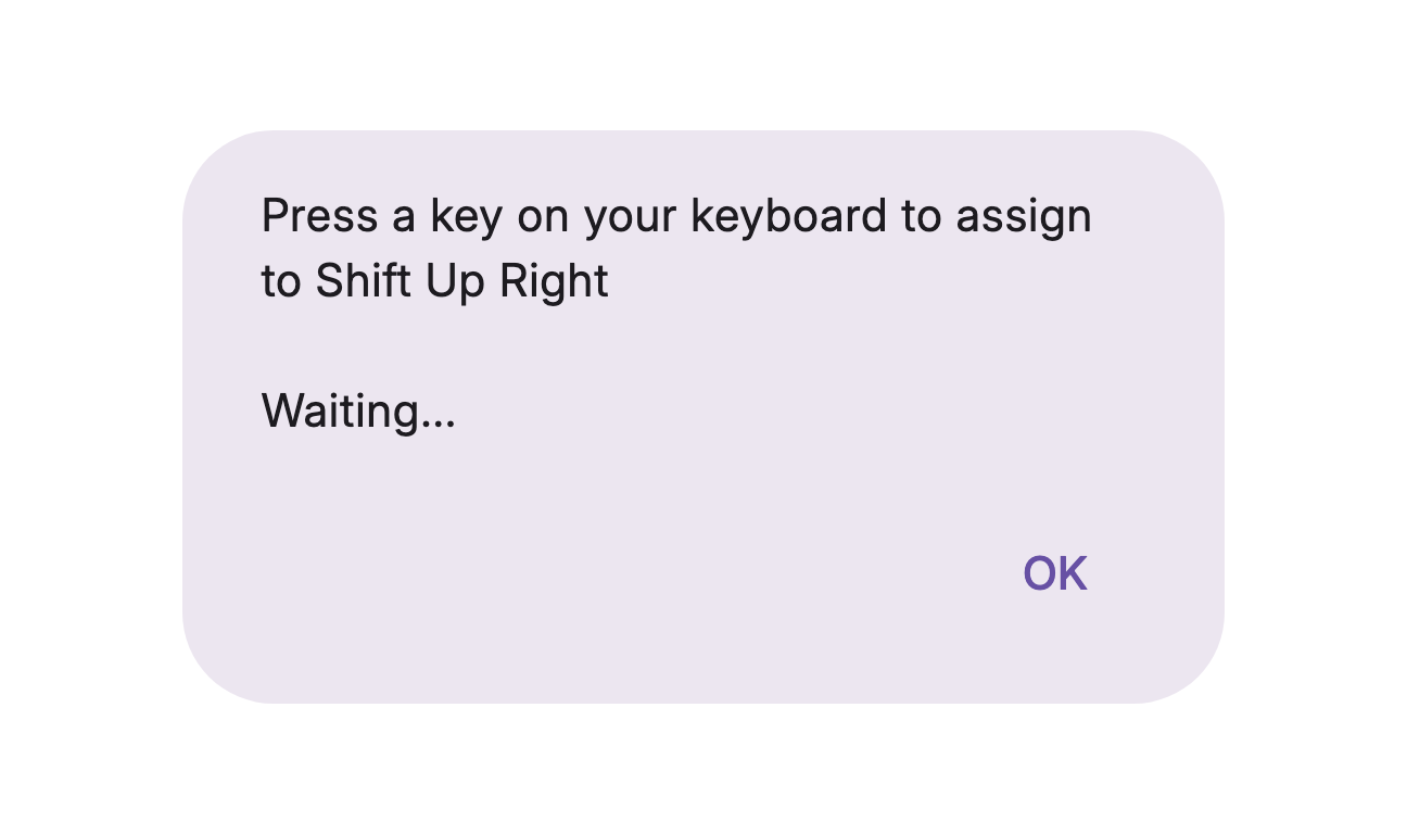A dialog reading "Press a key on your keyboard to assign to Shift Up Right" with "Waiting..." underneath and an OK button