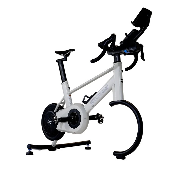 Stages SB200 smart bike from the side, with drop handlebars, shifters and a tablet mount